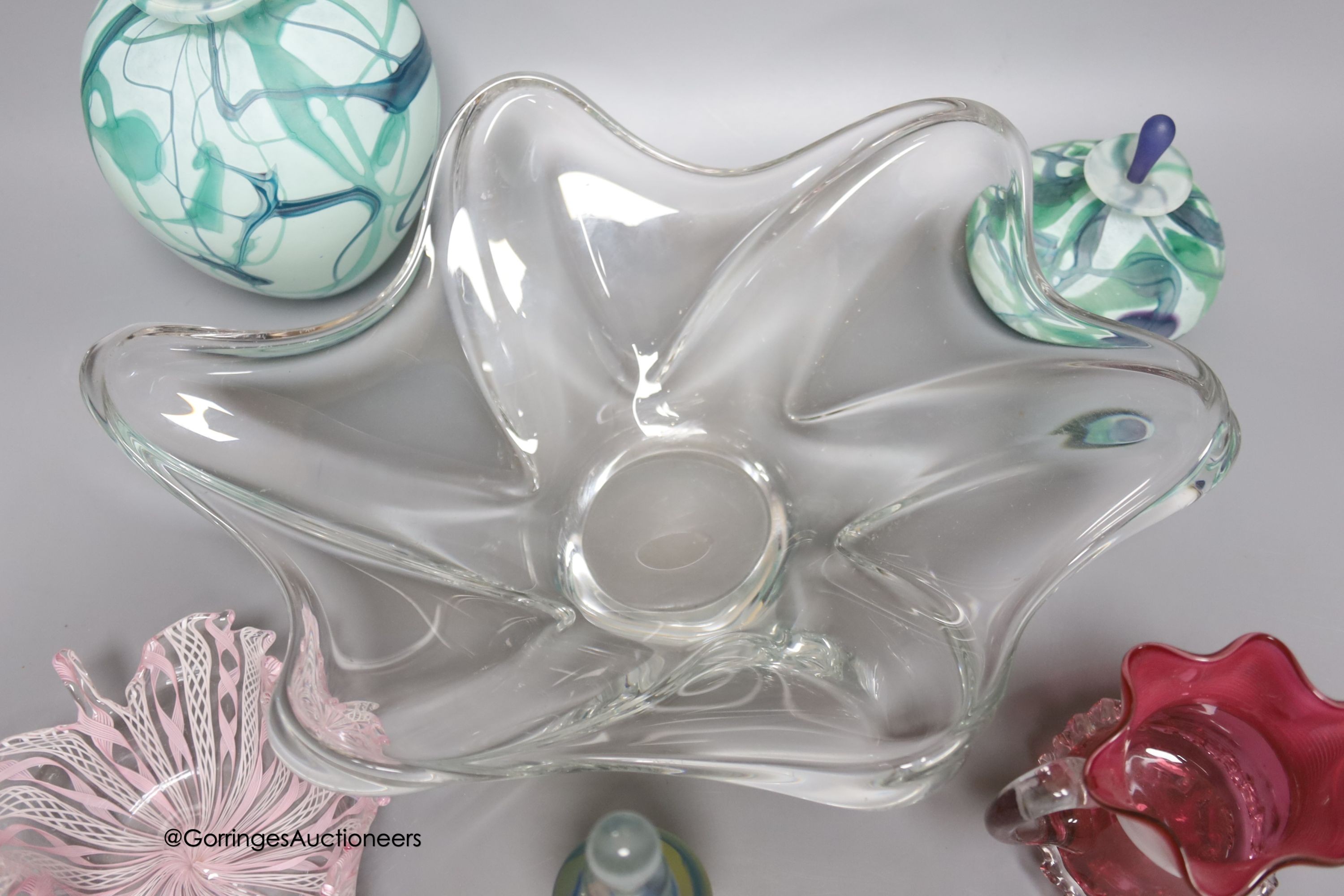 A Daum clear free form bowl, two signed art glass pieces and three other items of glass